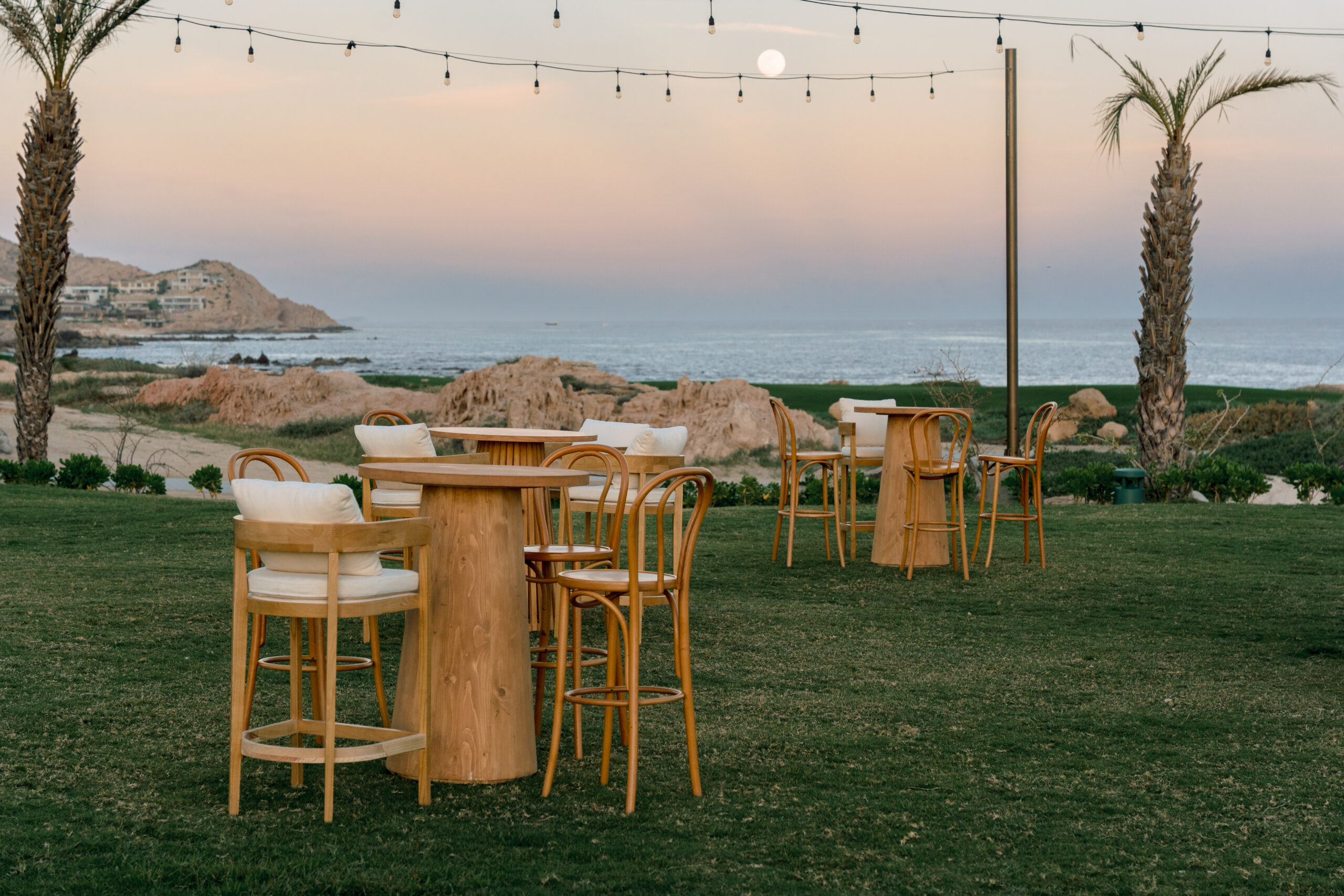 Outdoor dining tables and chairs at Park Hyatt Los Cabos wedding by ocean