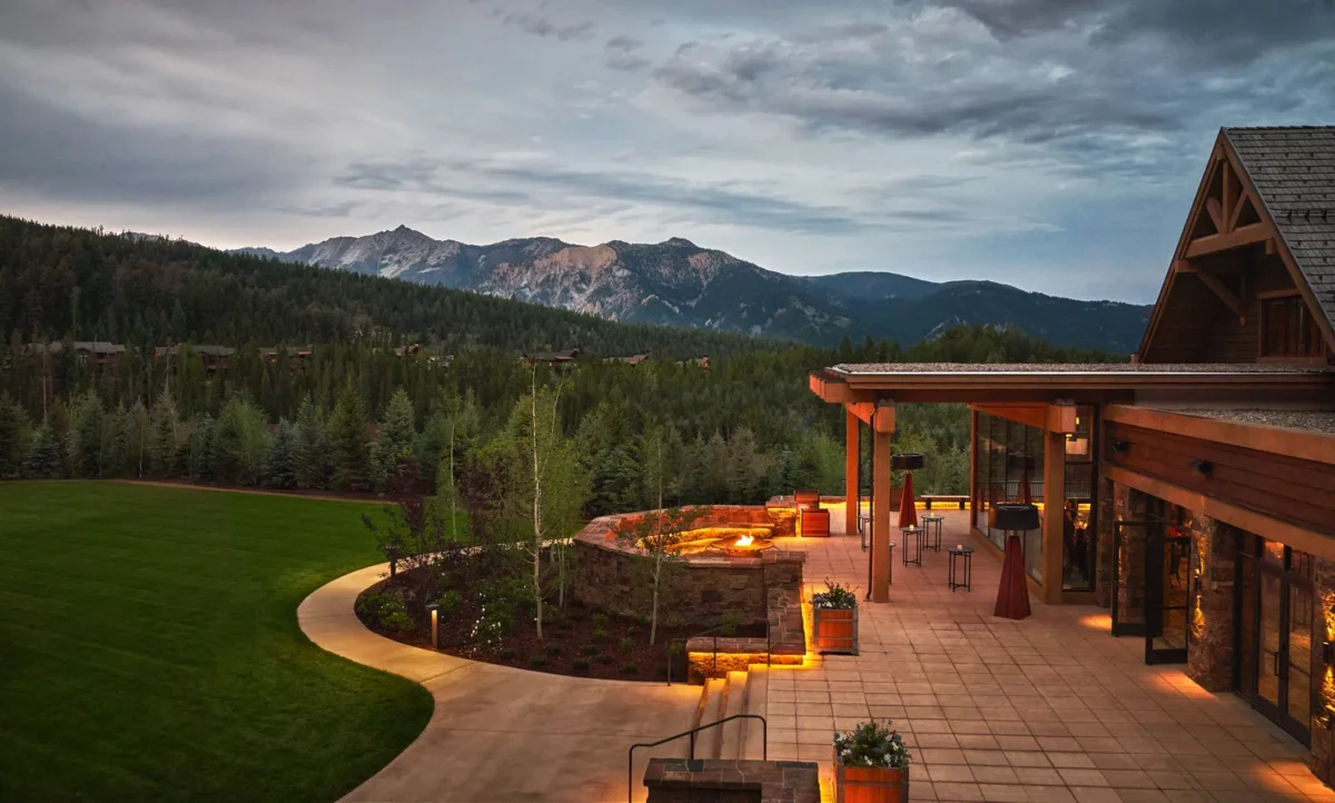 Montage Big Sky, a Montana wedding venue, with a scenic outdoor patio overlooking mountains and a green lawn.