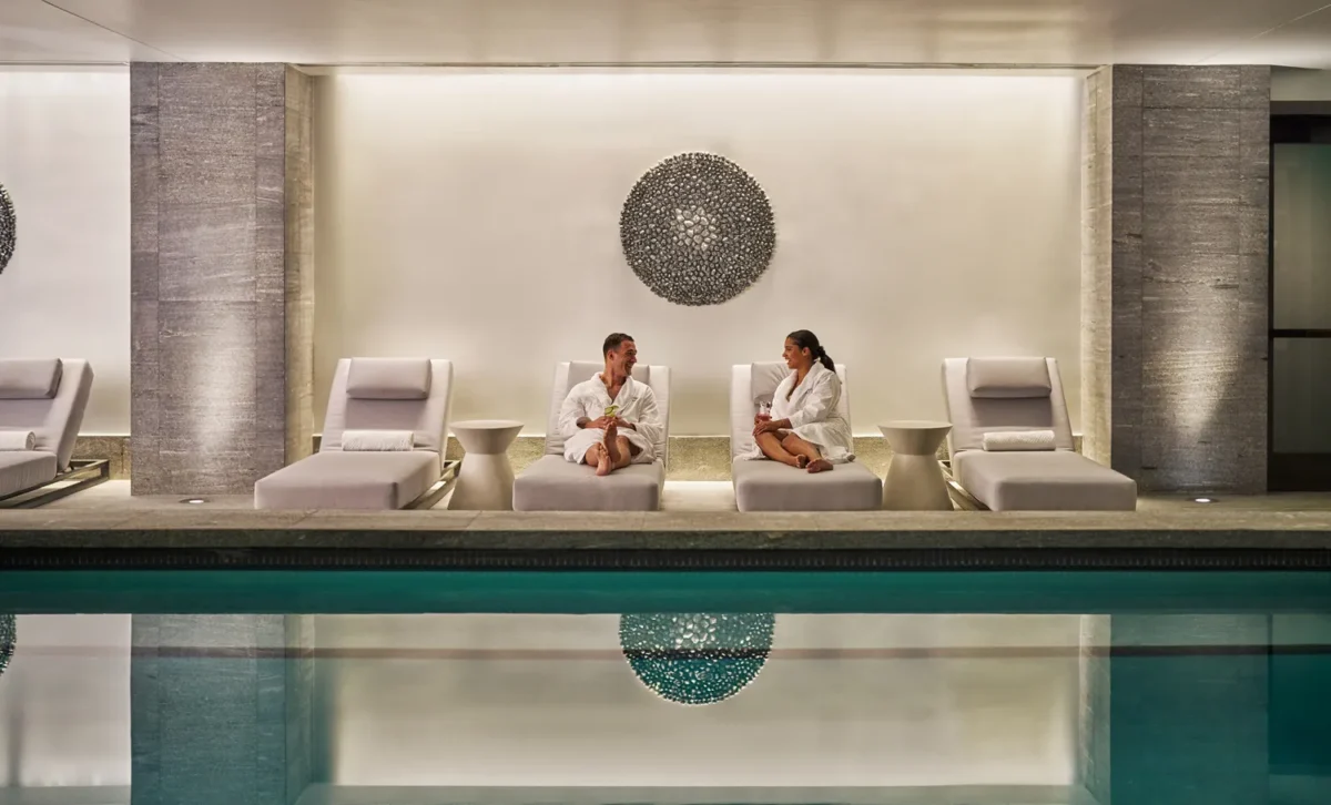 Couple relaxing at Montage Big Sky spa, enjoying drinks by the pool.