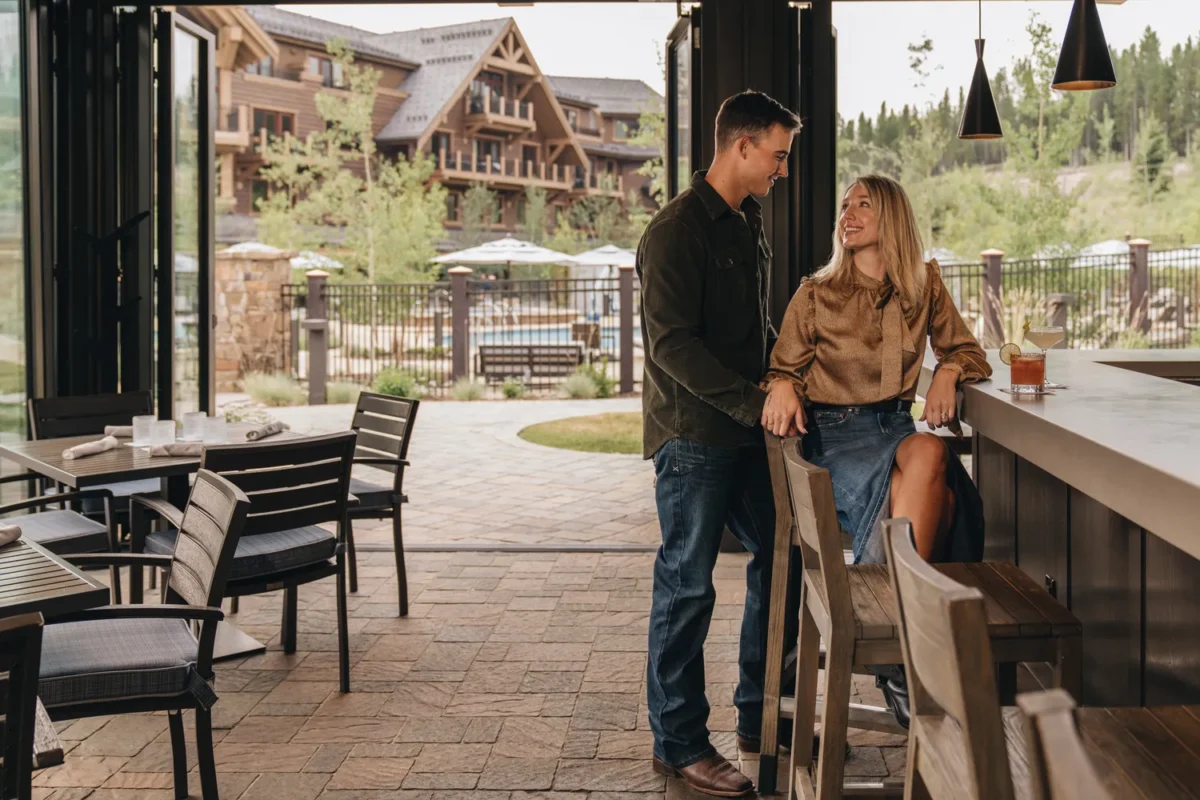 Couple at Montage Big Sky bar, ideal Montana wedding venue backdrop.