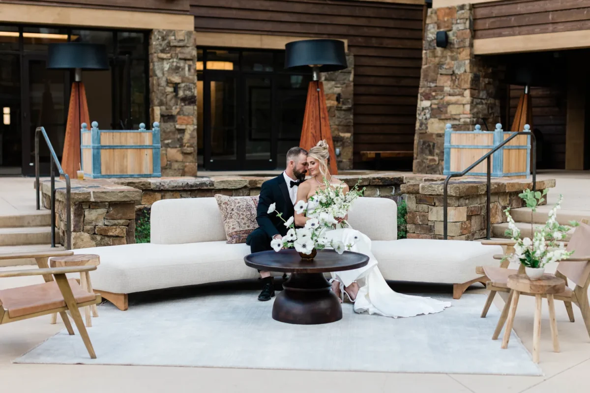 Bride and groom at a Montana wedding venue, Montage Big Sky, on a white couch