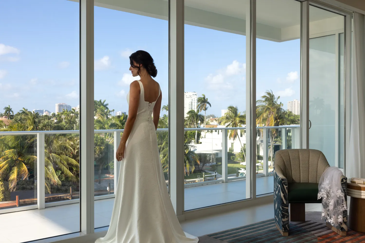 Bride in wedding dress looking out at Fort Lauderdale from Pier Sixty-Six wedding venue.