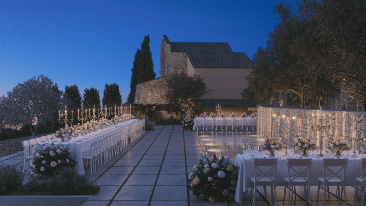Elegant outdoor dining setup at dusk in a villa courtyard