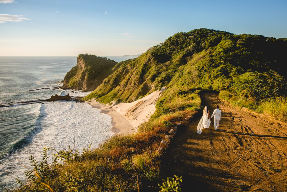 Couple walking along coastal path at Rancho Santana with ocean view