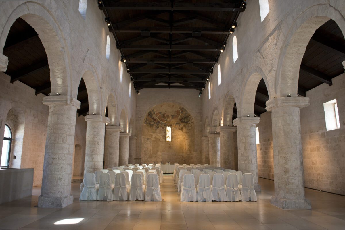 Relais Histò wedding setup: Chairs in a historic Italian church.