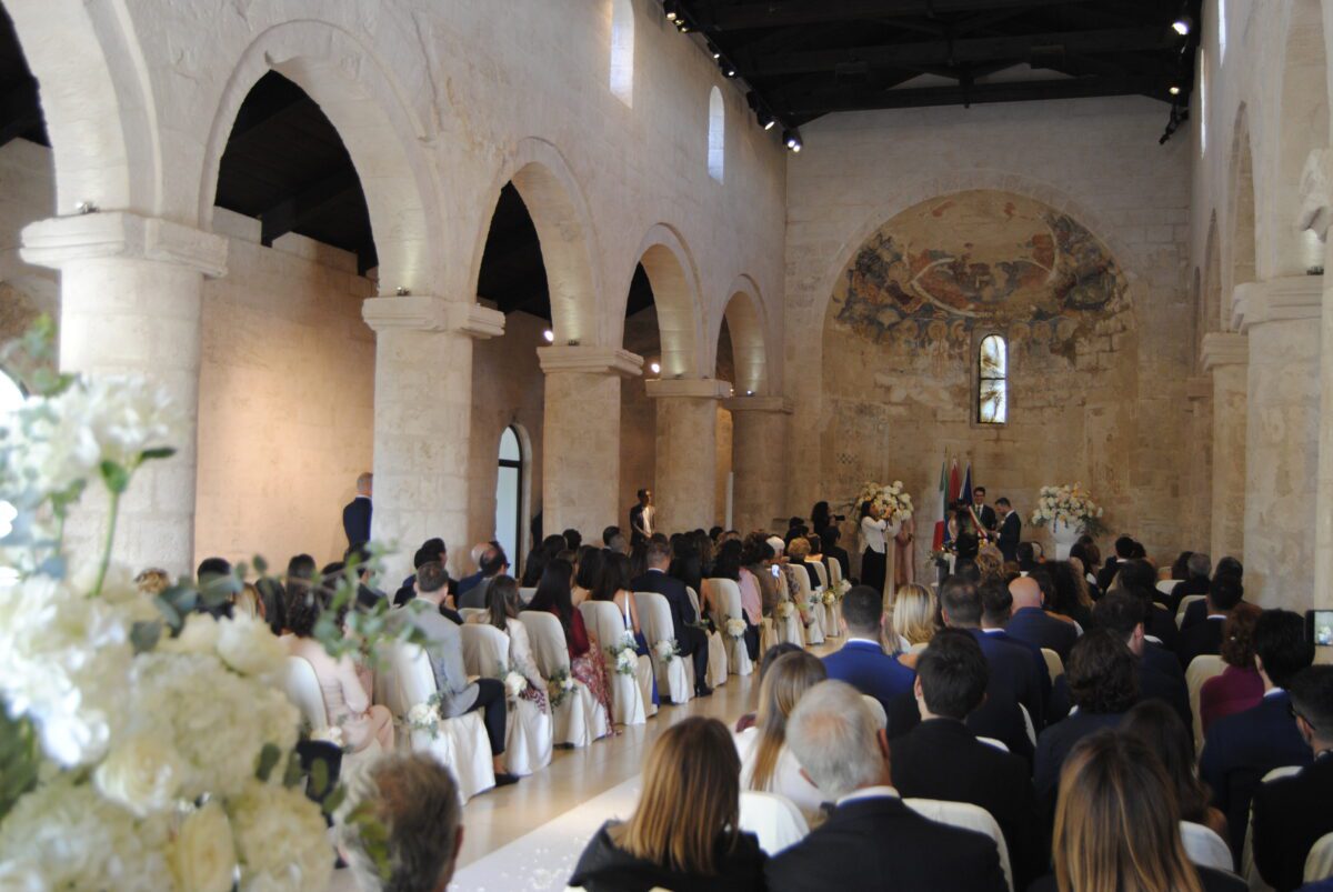 Wedding ceremony at Relais Histò, a hotel and spa, with guests seated in a historic church.