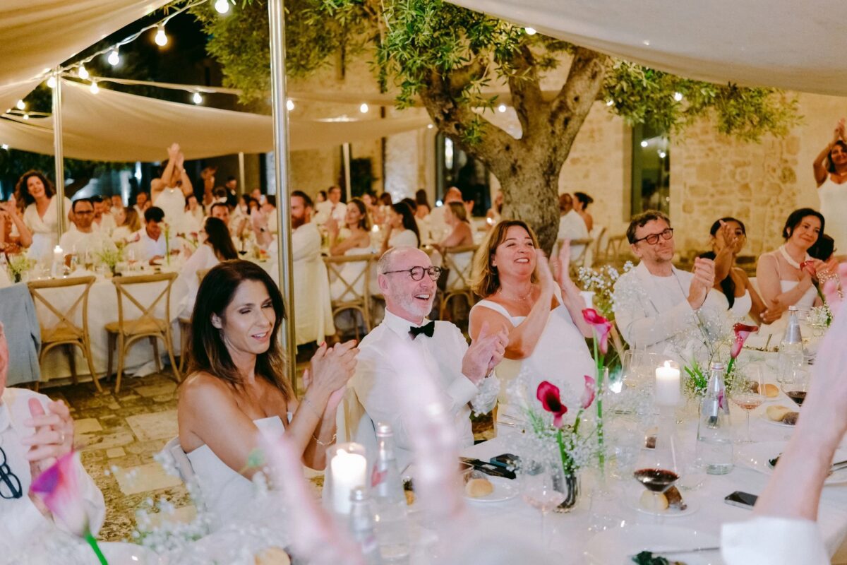 Wedding reception at Relais Histò, guests clapping at dinner
