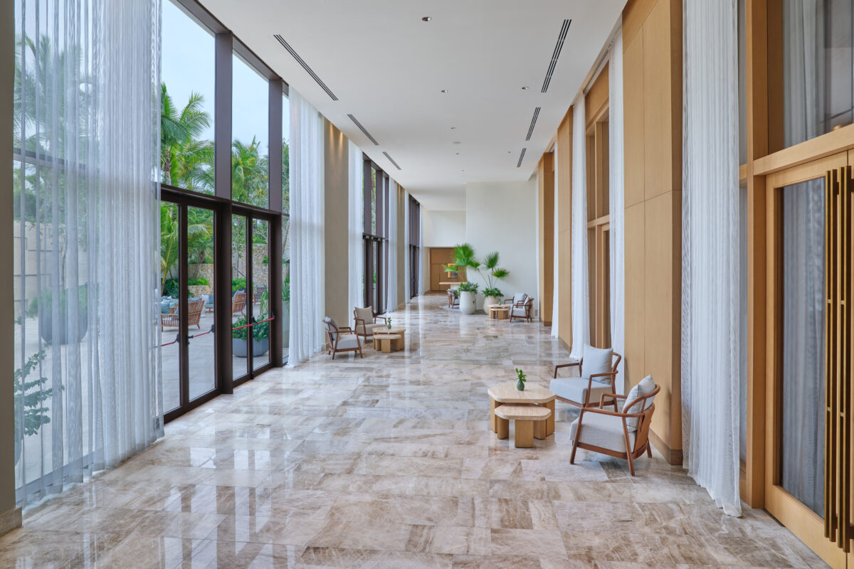 Hallway at The St. Regis Cap Cana Resort with seating and views of tropical greenery. Exclusive wedding resorts in Punta Cana.