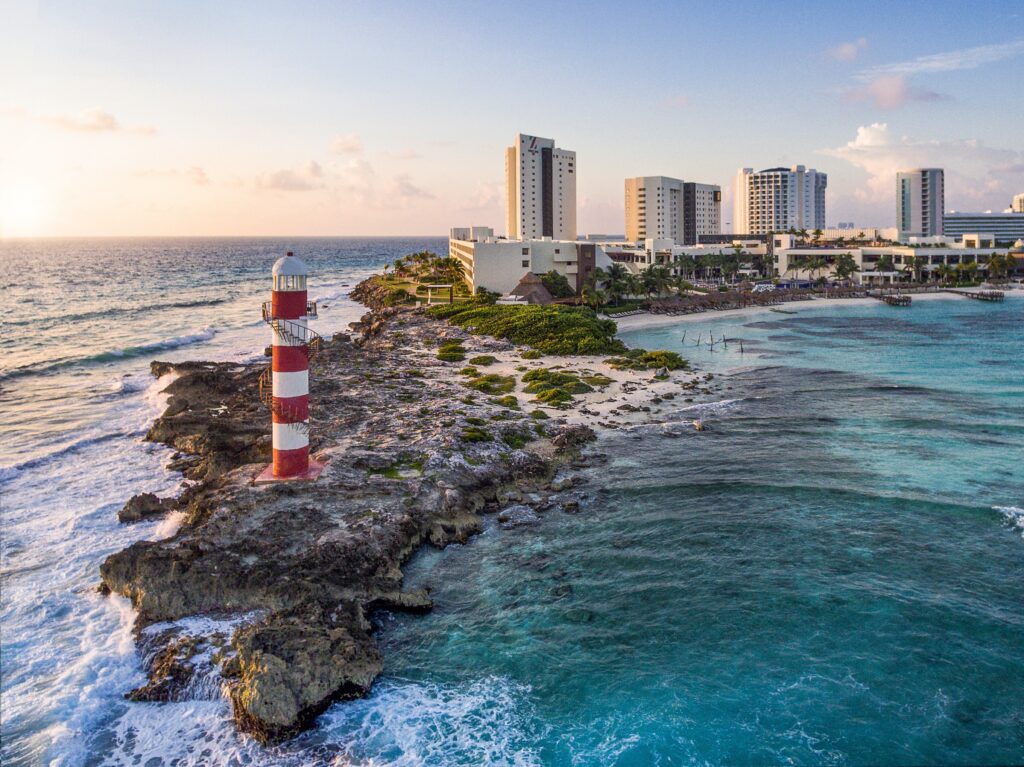 Cancun lighthouse on rocky shore near Hyatt Ziva, a luxury wedding venue in Cancun with ocean views.