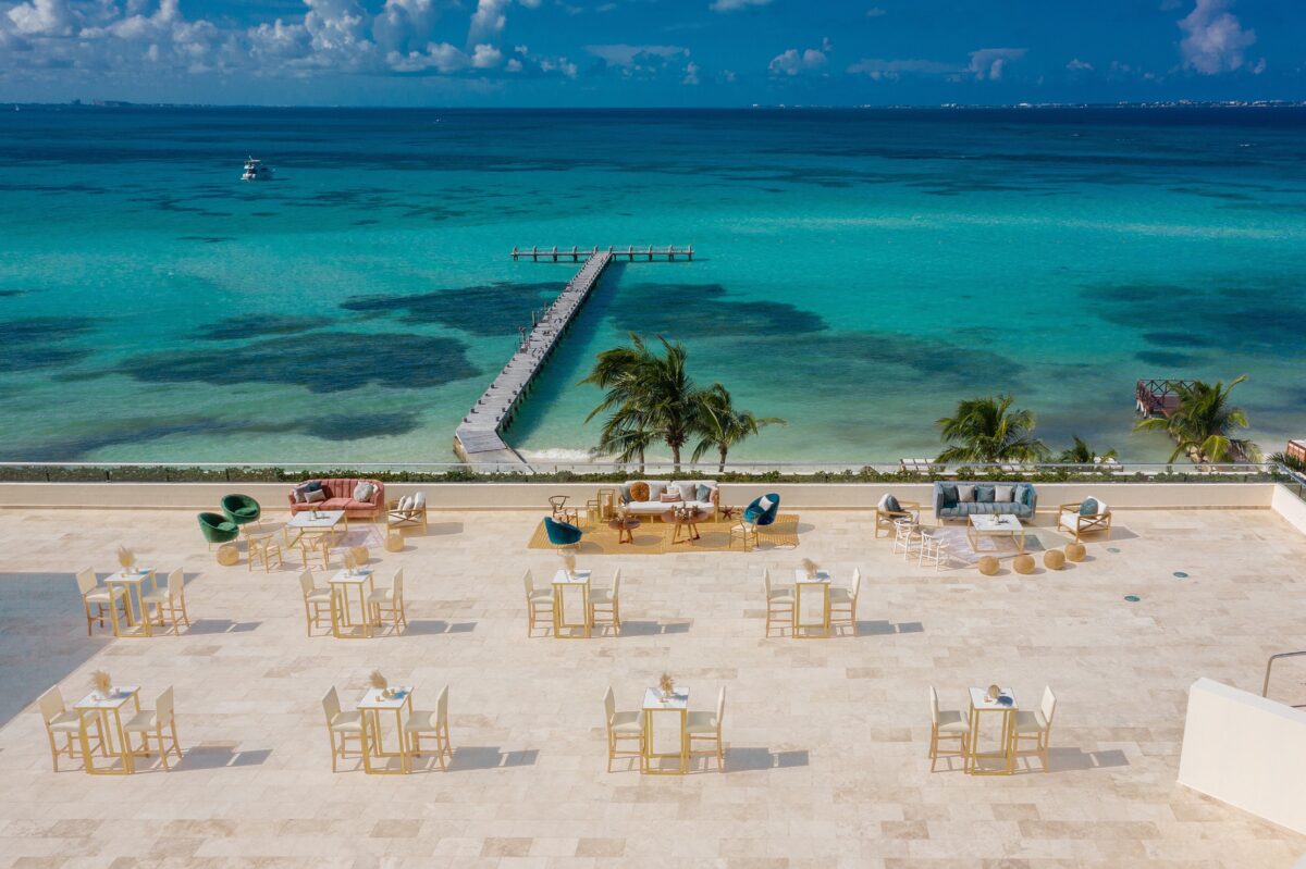 Hyatt Ziva Cancun luxury wedding venue with beachfront tables, lounge areas, and a pier over turquoise water.