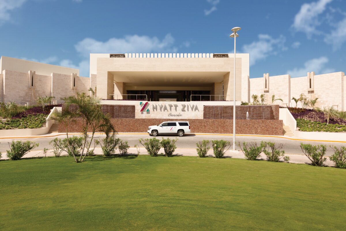 Hyatt Ziva Cancún entrance with a white SUV. Luxury wedding venue.