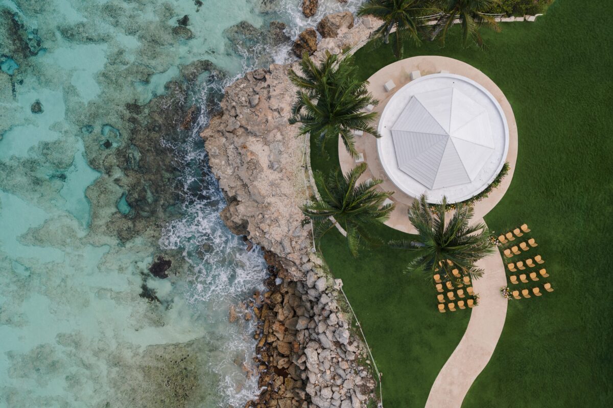 Luxury wedding venue in Cancun: Aerial view of oceanside gazebo and seating.