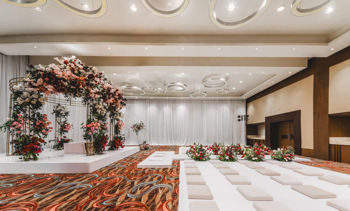 Luxury wedding venue in Cancun: Elegant ceremony setup with floral arch and seating.