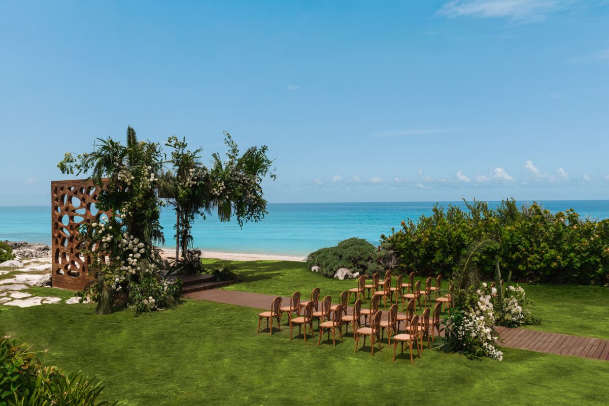 Luxury wedding venue in Cancun with ocean views and beautiful floral arch.