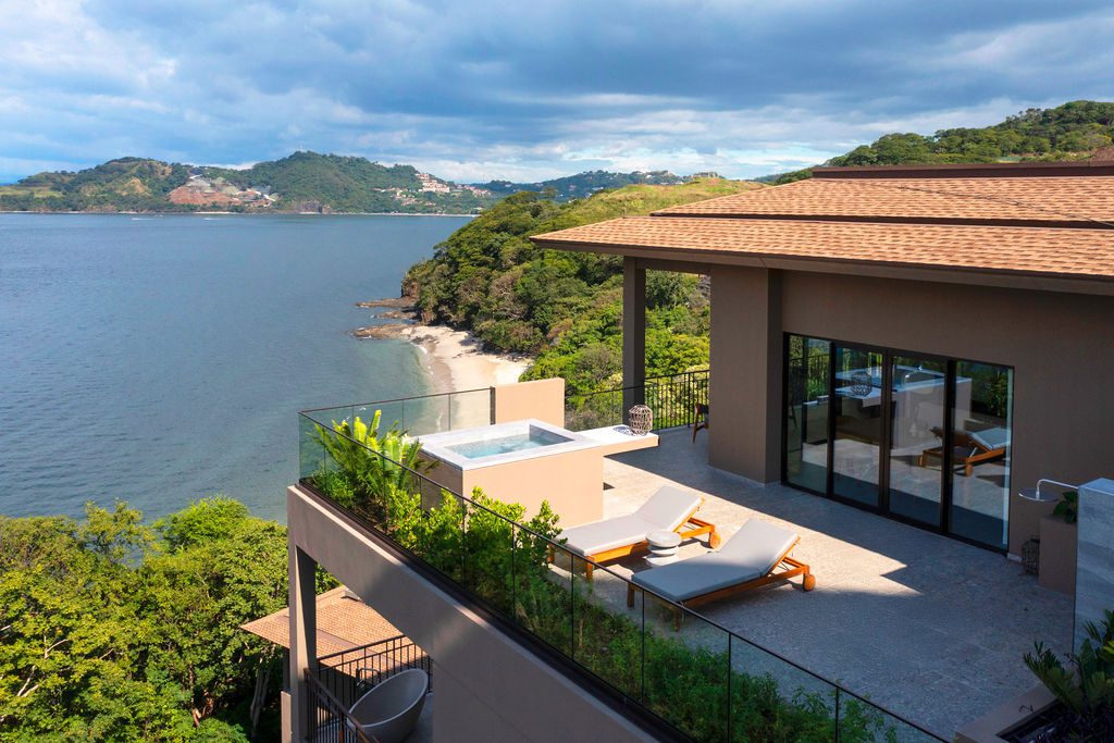 Luxury villa at Waldorf Astoria Costa Rica overlooking the ocean with a private plunge pool and lounge chairs.
