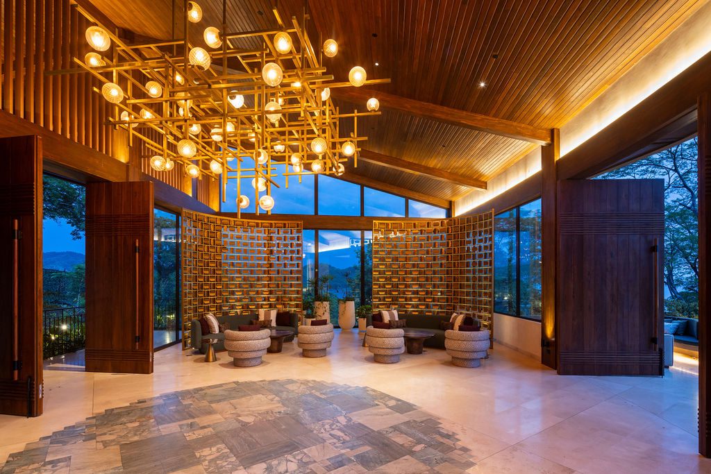 Waldorf Astoria Costa Rica lobby with wood accents, modern lighting, and mountain views.