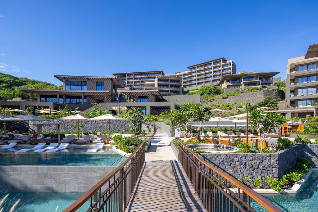 Waldorf Astoria Costa Rica resort view with pools, landscaping, and modern architecture.