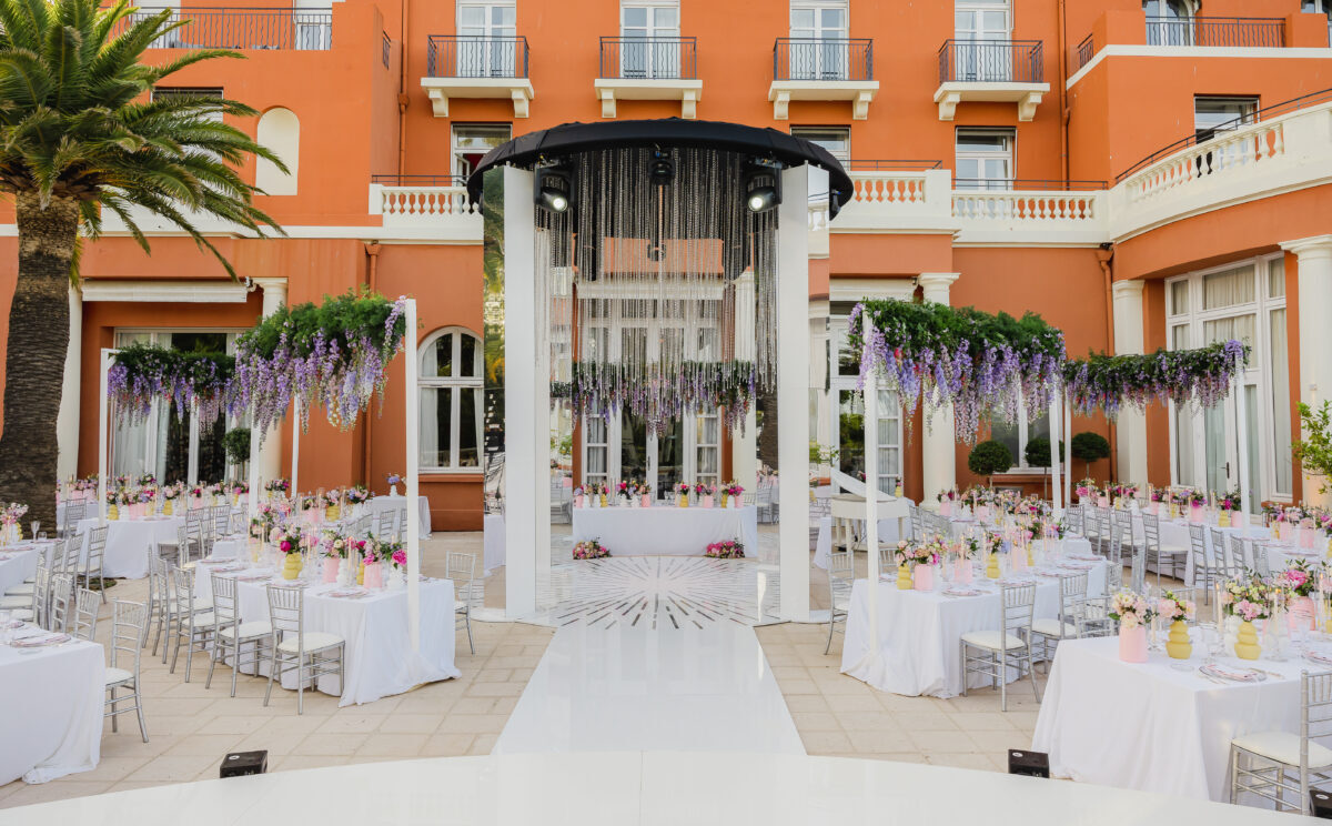 Luxury wedding setup at COMO Le Beauvallon in Saint-Tropez. Tables and floral decorations under a modern canopy.