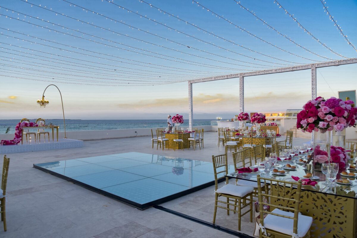 Outdoor luxury wedding venue in Cancun at the Hyatt Ziva, with tables set for a reception under string lights.