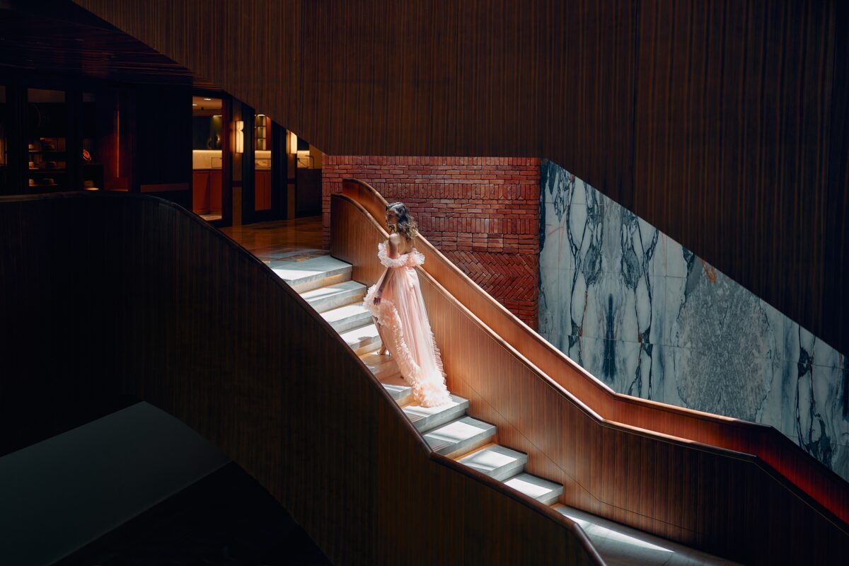 Woman in gown on stairs at The St. Regis Cap Cana Resort, a stunning venue for exclusive weddings in Punta Cana.
