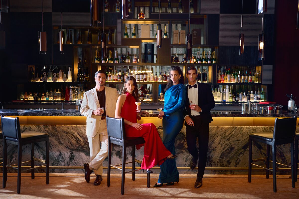 Elegant group at a bar, St. Regis Cap Cana Resort.