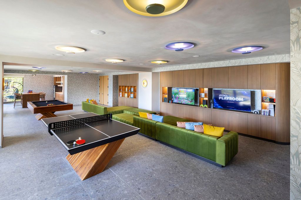 Game room at Waldorf Astoria Costa Rica with pool table, ping pong, and lounge seating.