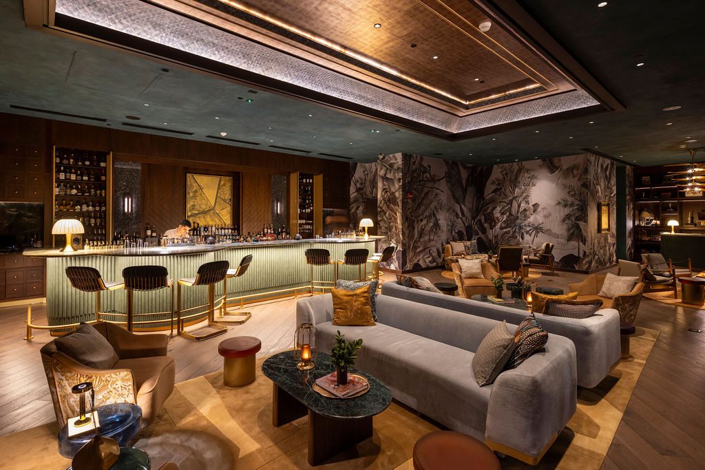 Luxurious bar and lounge at the Waldorf Astoria Costa Rica, featuring stylish seating and a fully stocked bar.