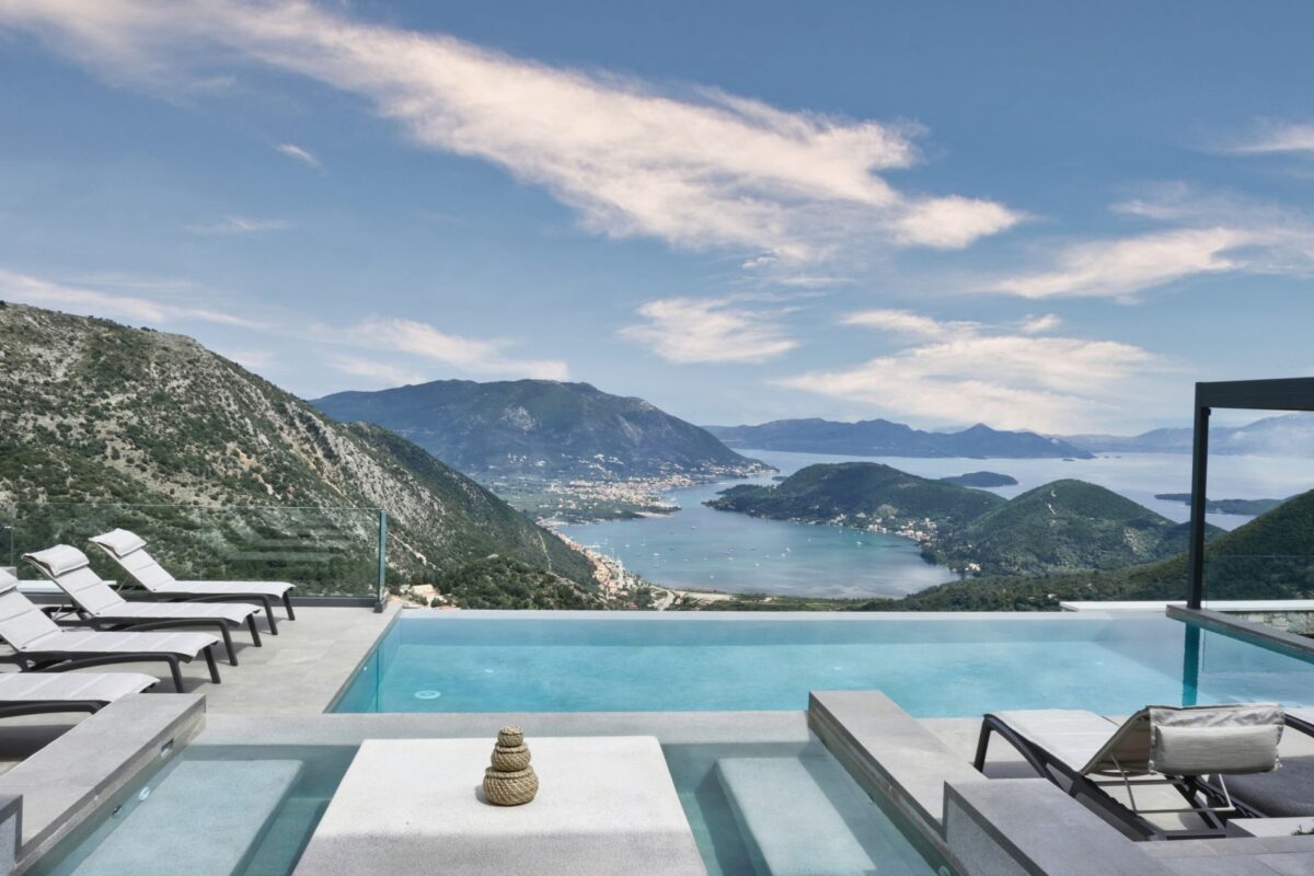 Luxury villa rental with infinity pool overlooking a scenic bay.