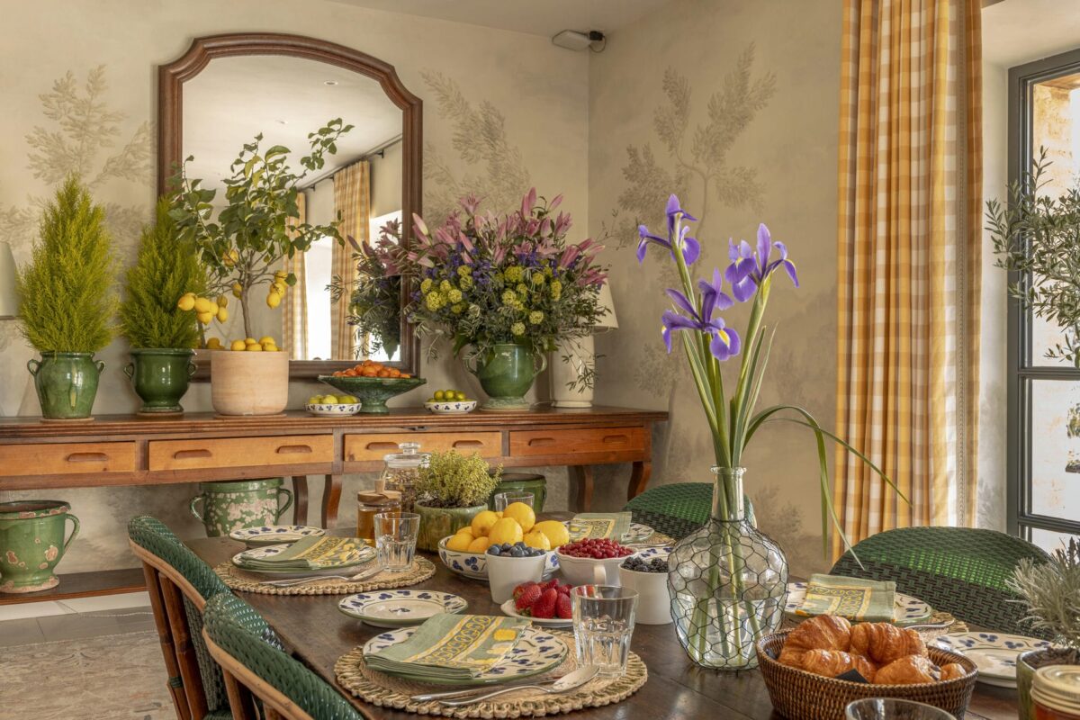 Luxury villa rentals: Breakfast table setting with fruit and flowers.
