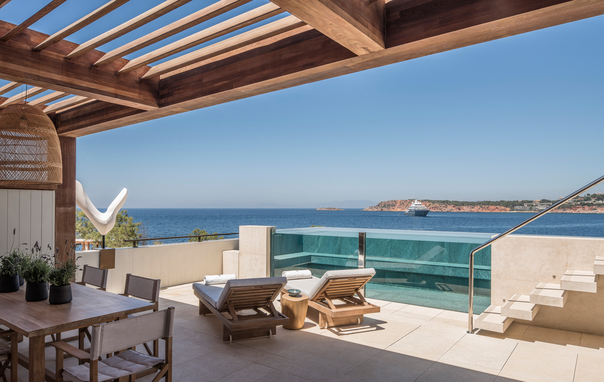 Four Seasons Astir Palace Hotel Athens: Luxurious poolside view with ocean and cruise ship.