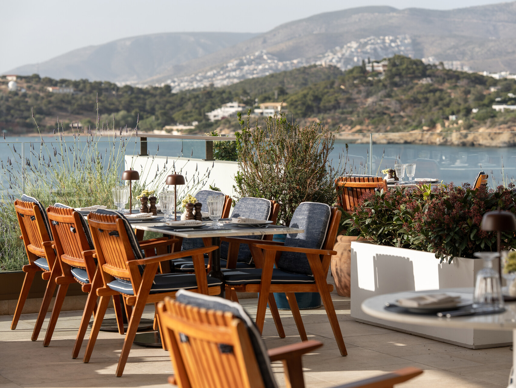Outdoor dining at Four Seasons Astir Palace Hotel Athens with ocean view.