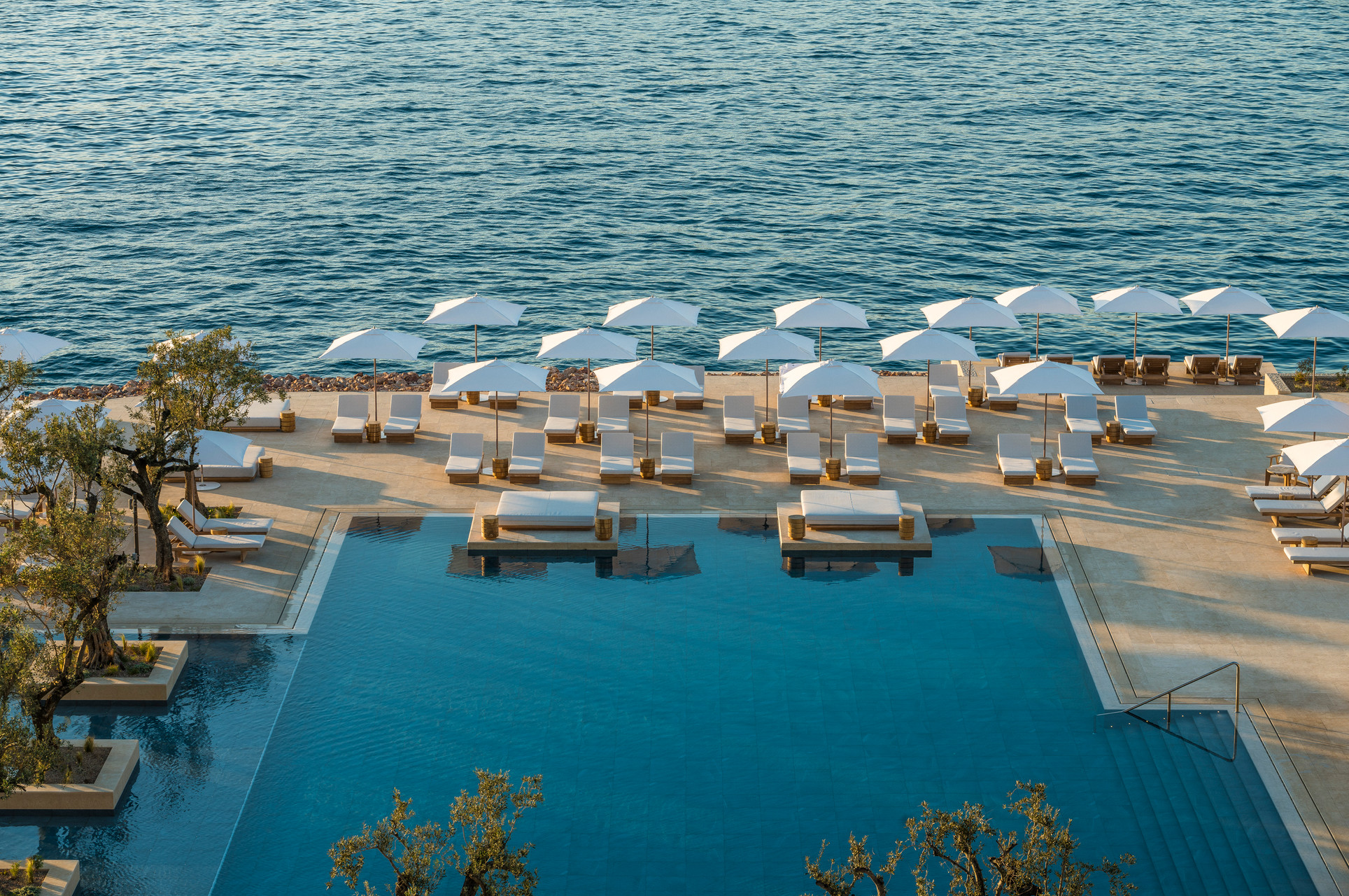 Four Seasons Astir Palace Athens pool and seaside lounge area.