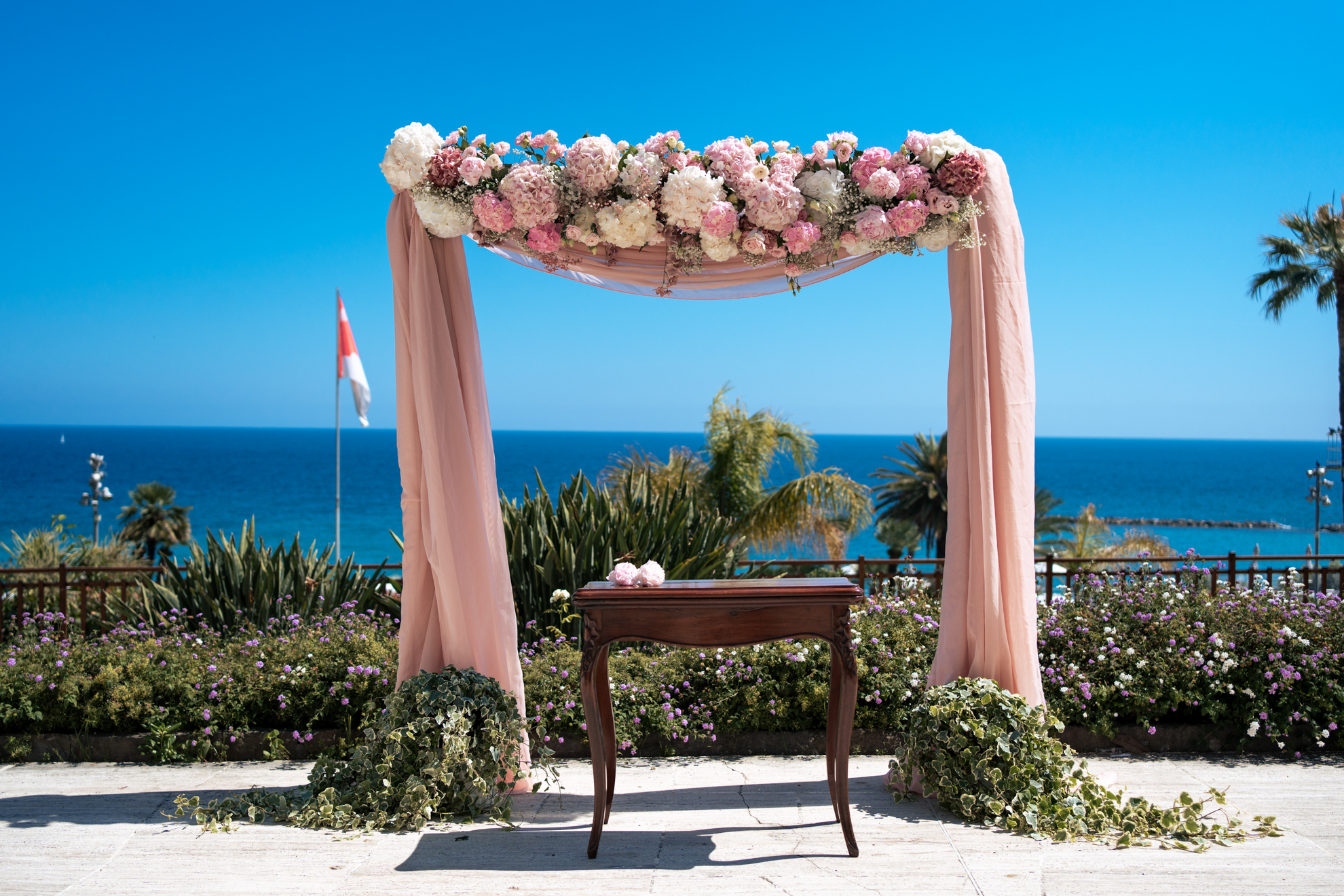 Wedding chuppah with pink flowers at Royal Hotel Sanremo, ocean view.