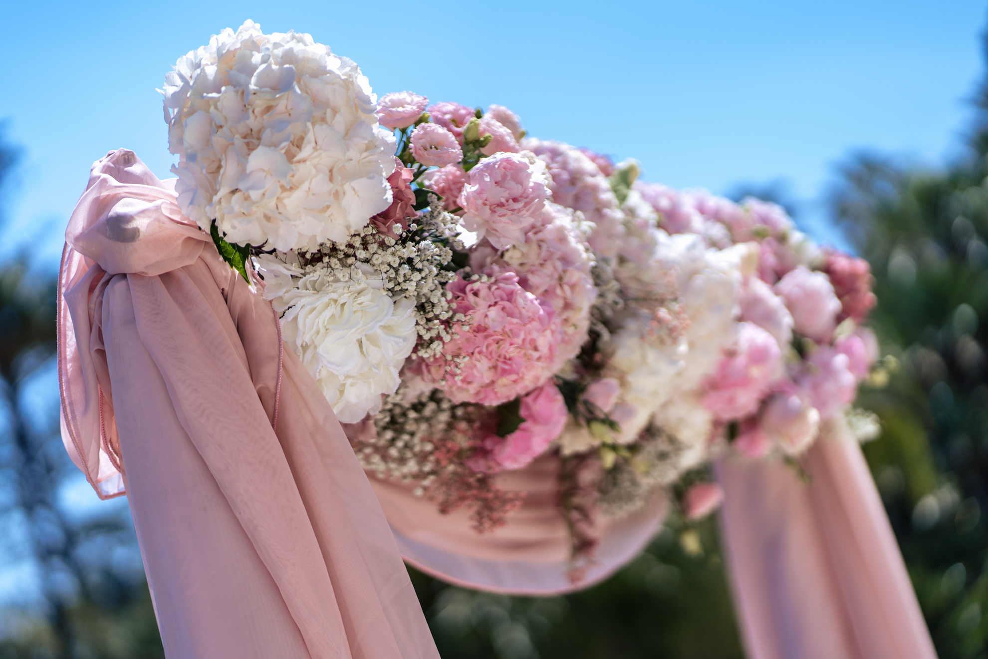 Floral wedding arch with pink and white flowers at Royal Hotel Sanremo.