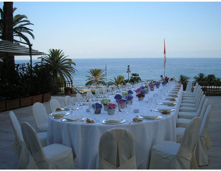 Royal Hotel Sanremo: Elegant outdoor dining table set with ocean view.