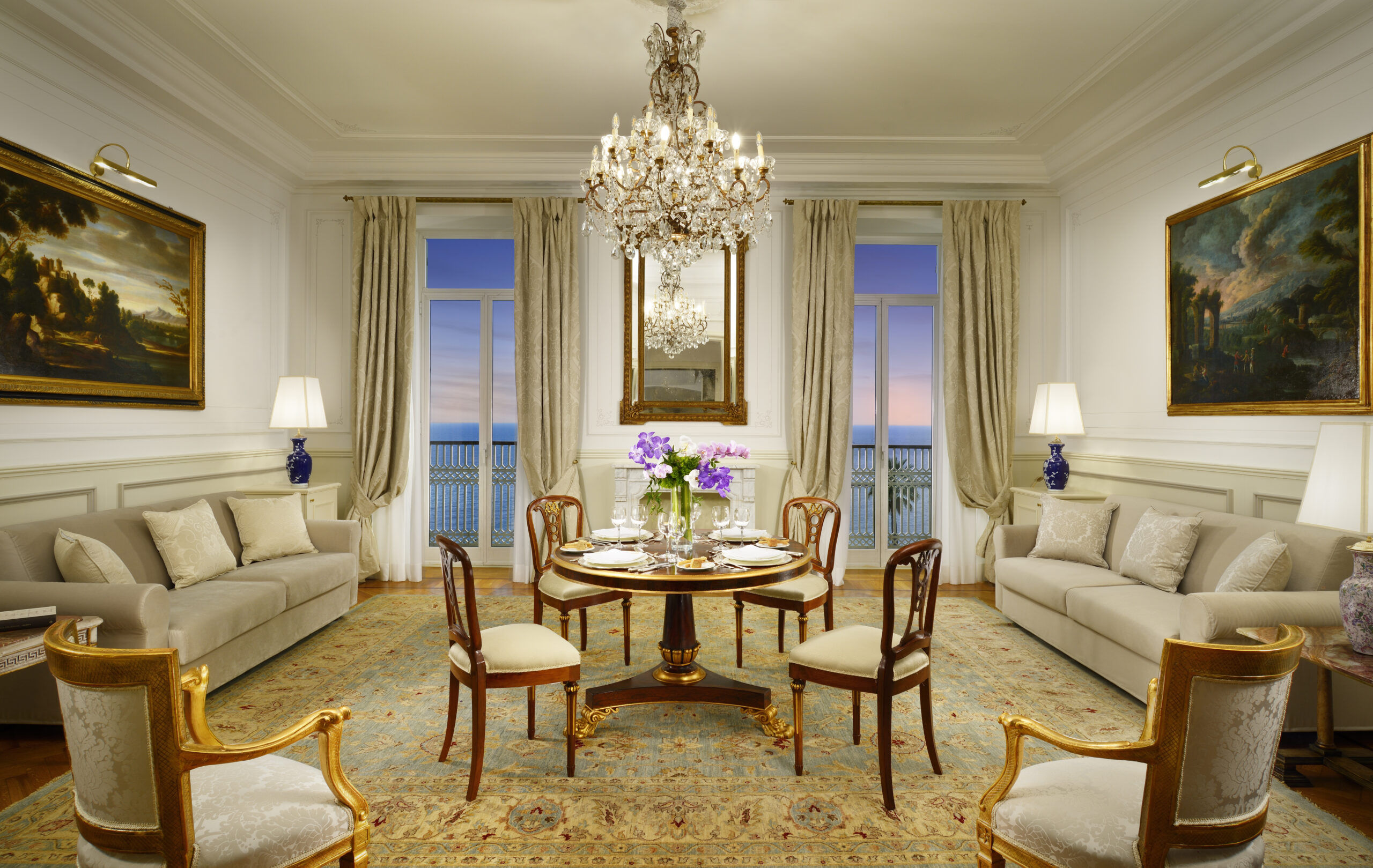 Luxury dining room at Royal Hotel Sanremo, a Sanremo wedding venue, with chandelier and ocean view.