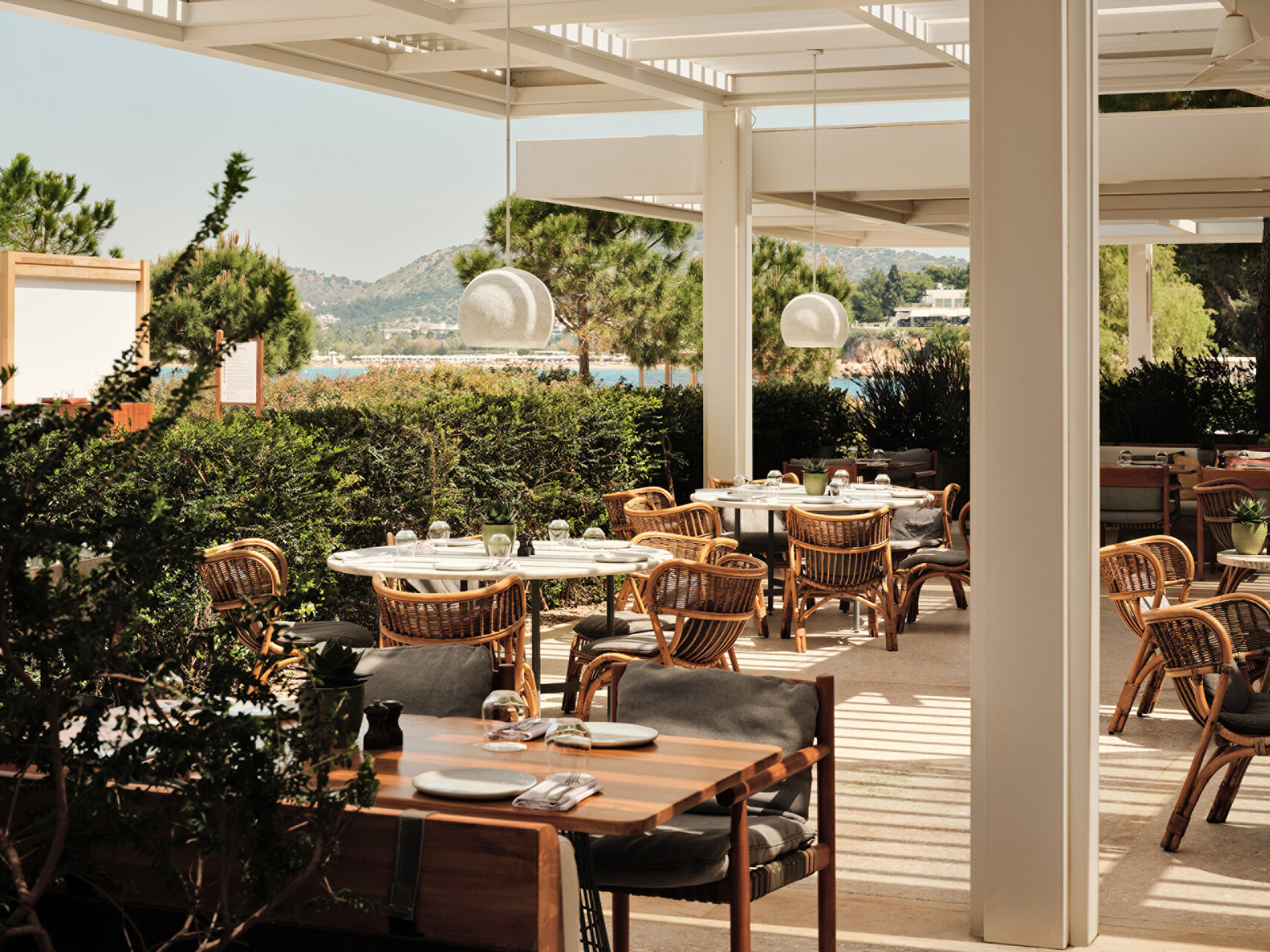 Outdoor dining at the Four Seasons Astir Palace Hotel Athens with sea view.