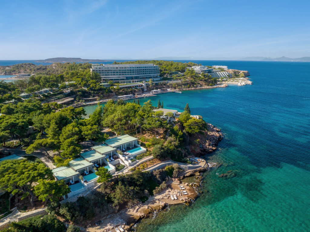 Four Seasons Astir Palace Hotel Athens aerial view, showcasing luxury villas and turquoise waters.