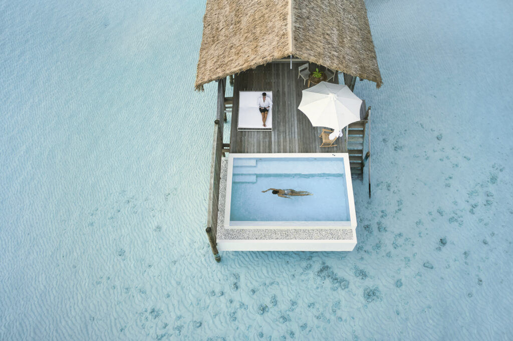 Couple relaxing at a luxury overwater bungalow with private pool in 2026