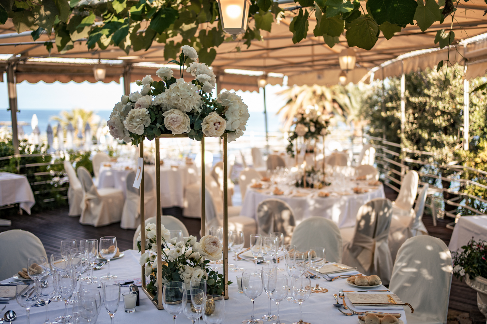 Luxury wedding venue in Sanremo: Elegant table setting at Royal Hotel Sanremo with floral centerpieces.