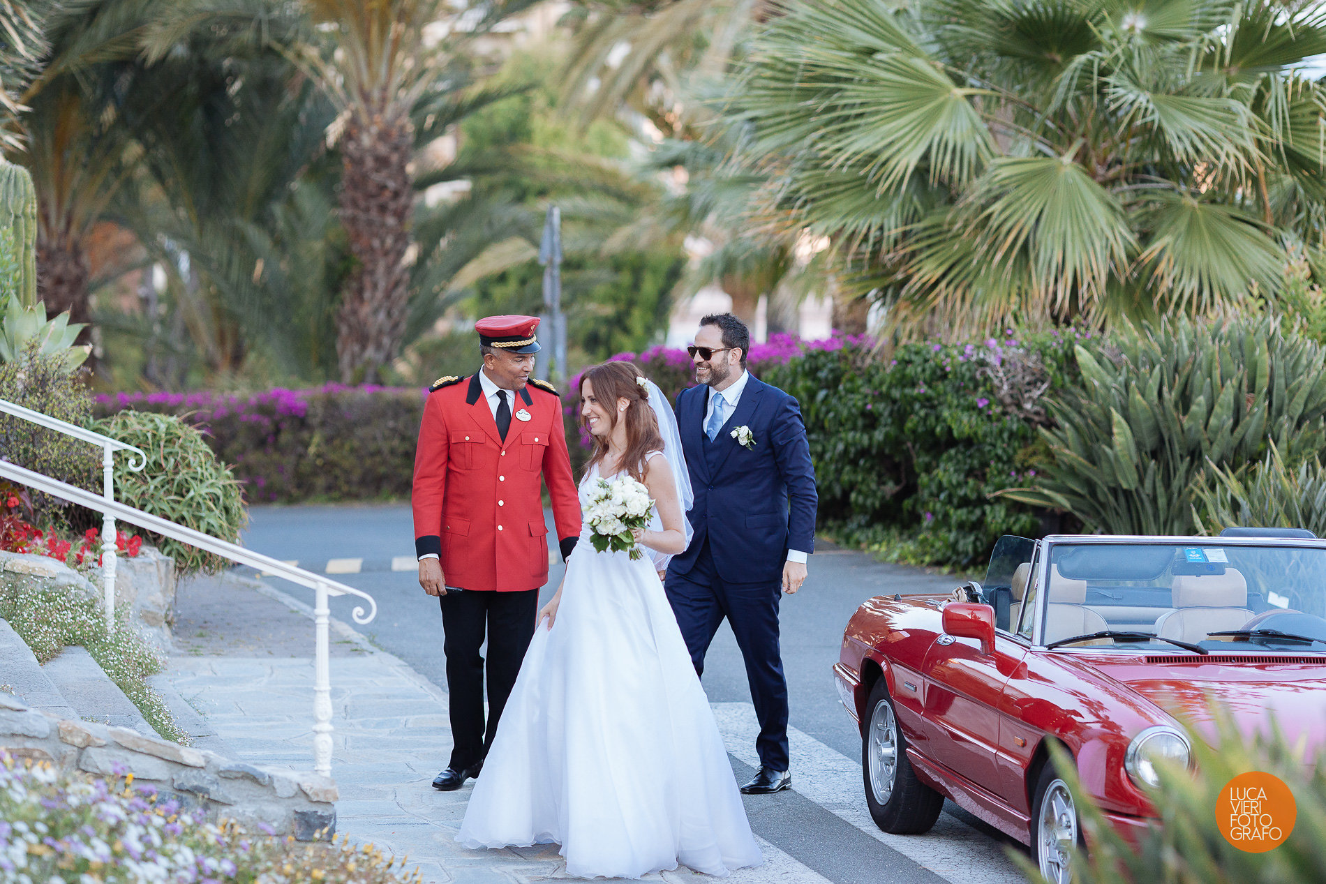 Bride, groom, and doorman at the Royal Hotel Sanremo, a luxury wedding venue.