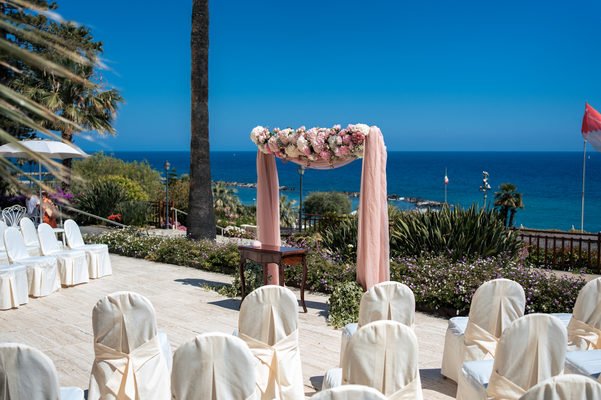 Outdoor wedding setup at Royal Hotel Sanremo, a luxury wedding venue in Sanremo, with ocean view.