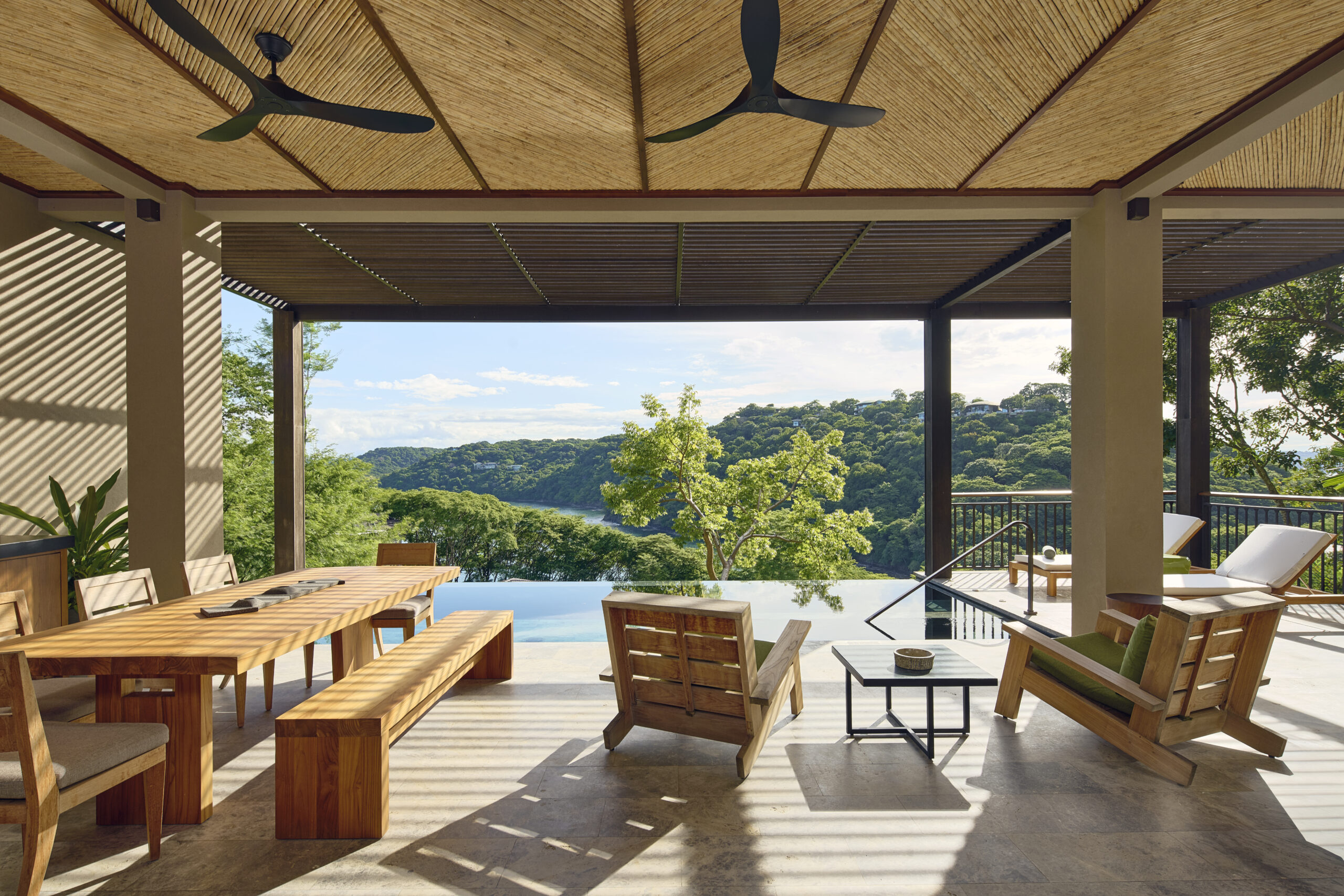Luxury Costa Rica wedding venue at Nekajui, a Ritz Carlton Reserve, with outdoor dining and infinity pool overlooking lush landscape.