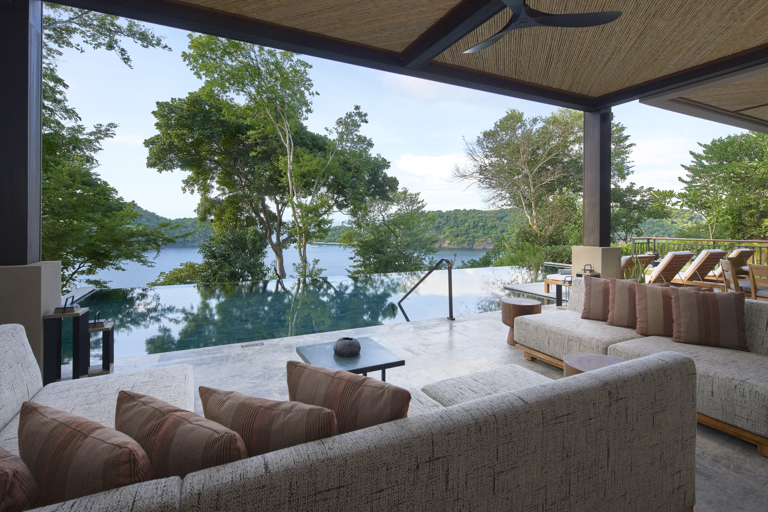 Nekajui, a Ritz Carlton Reserve view with infinity pool, ocean, and lounge seating. Ideal wedding venue in Costa Rica.