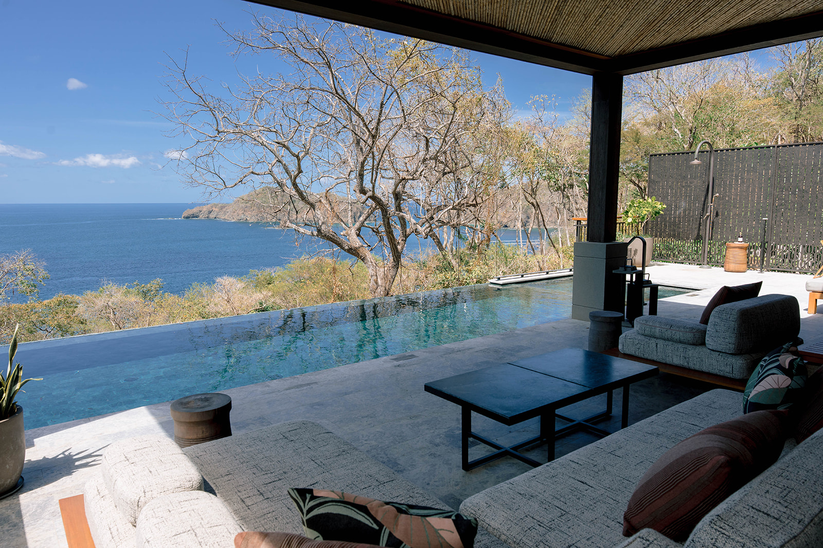 Nekajui Ritz Carlton Reserve infinity pool overlooking the ocean and lush landscape.