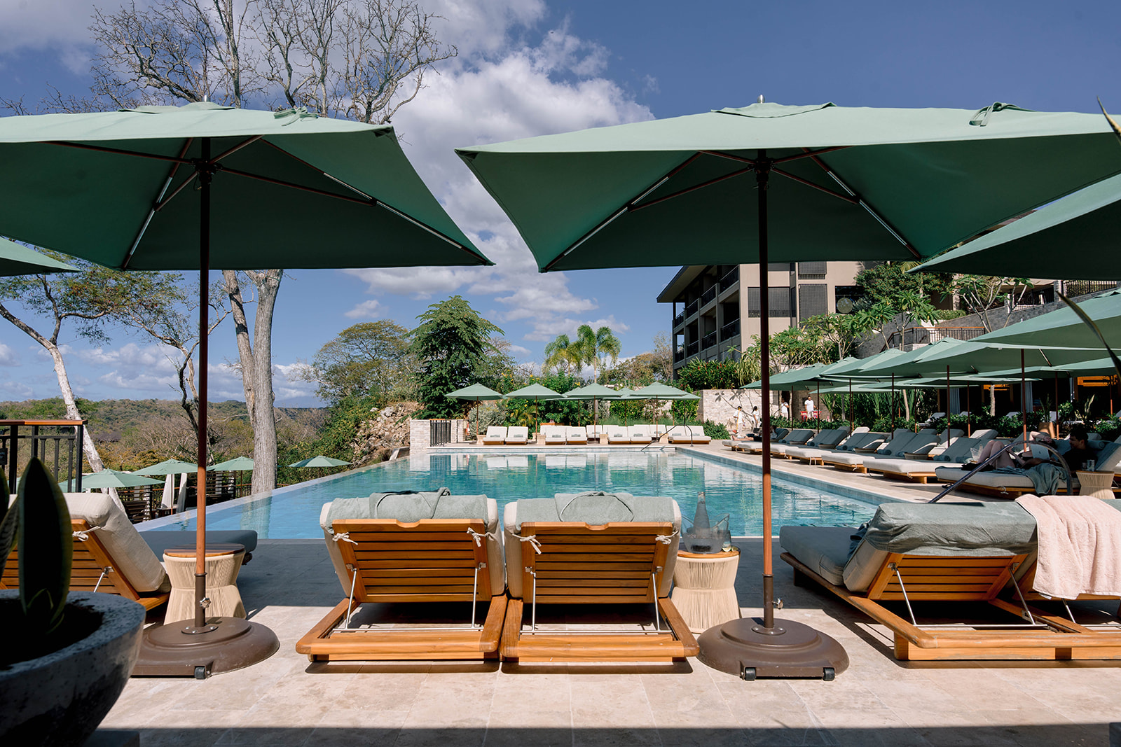 Nekajui Ritz Carlton Reserve pool with lounge chairs and umbrellas.