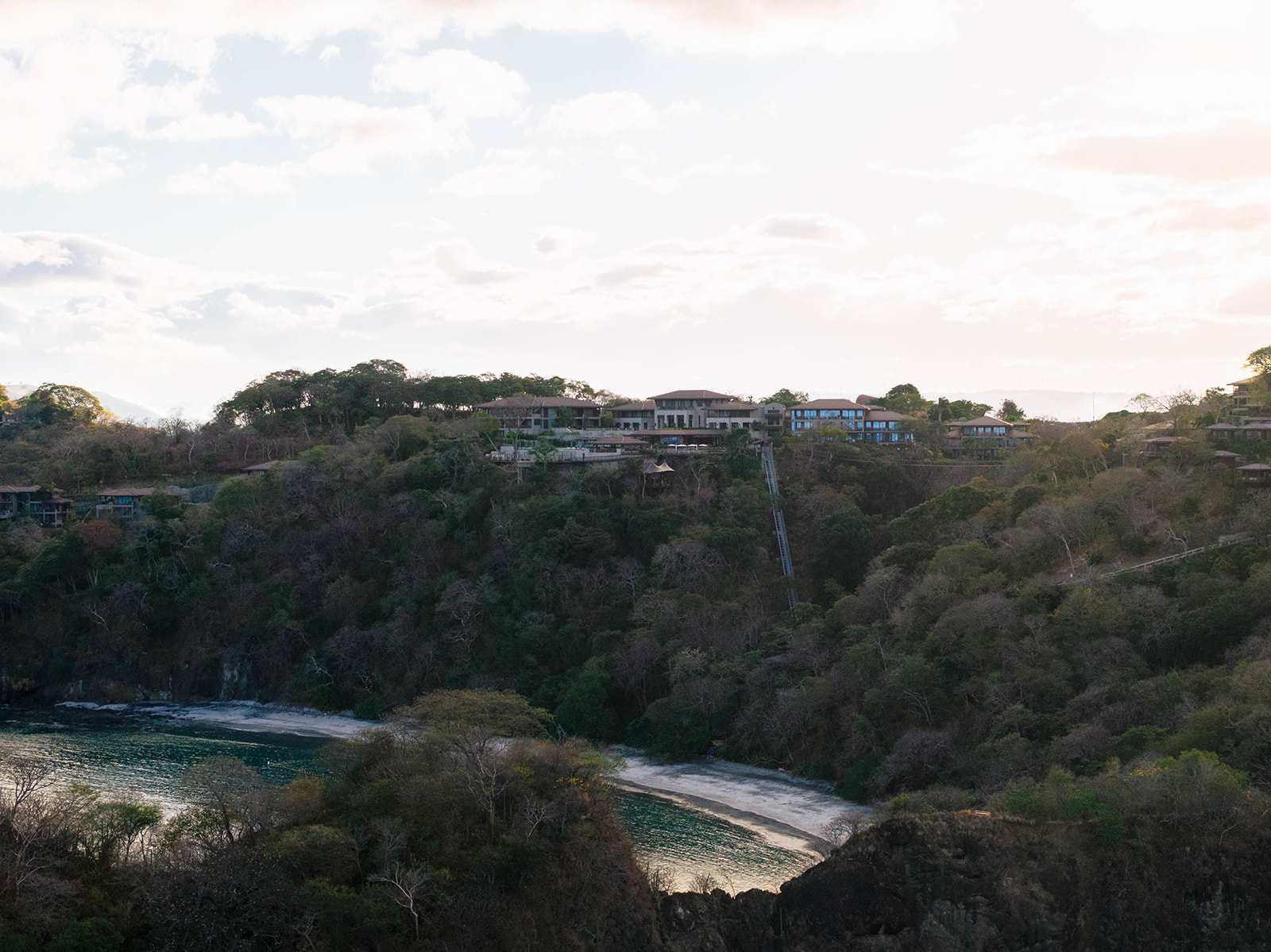 Nekajui, a Ritz Carlton Reserve, nestled on a lush hillside overlooking a secluded beach.