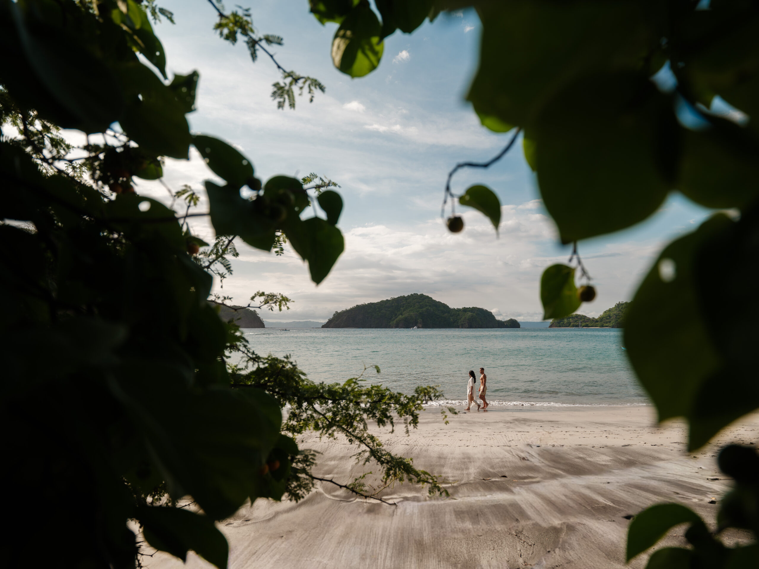 Couple walking on the beach at Nekajui, a Ritz Carlton Reserve, a wedding venue in Costa Rica.