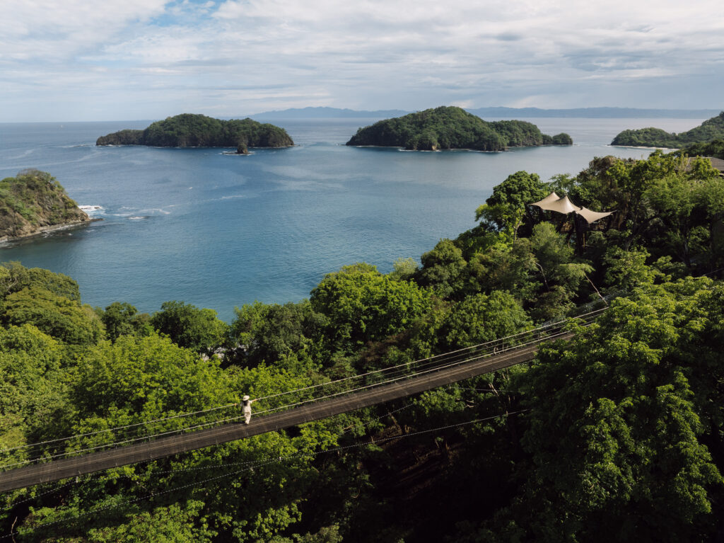 Suspension bridge at Nekajui, a Ritz Carlton Reserve, with islands in the background.