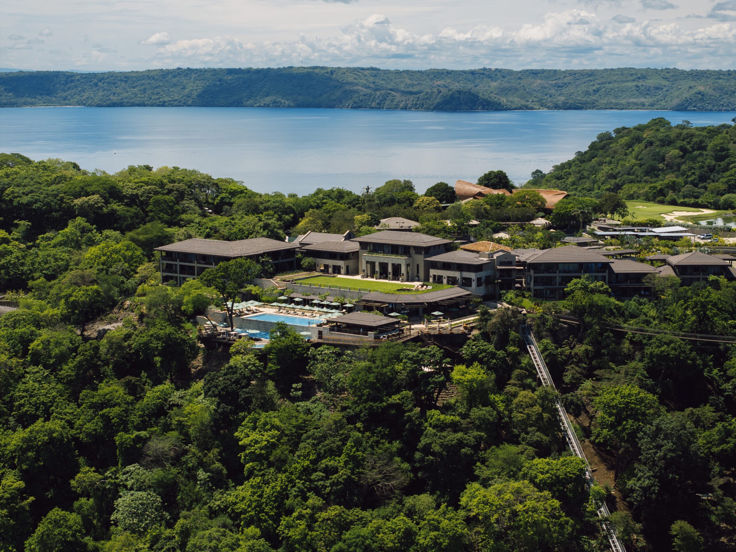 Nekajui, a Ritz Carlton Reserve, luxury resort with pool overlooking lake and lush Costa Rican landscape.